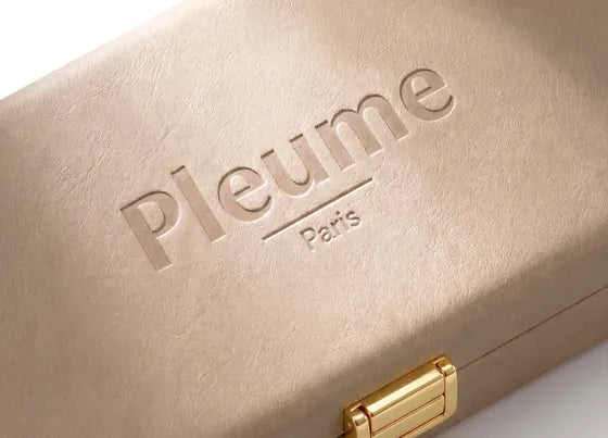 Genuine leather travel case with the Pleume name embossed on it